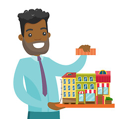 Image showing African real estate agent presenting city model.