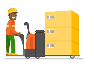 Image showing Young african warehouse worker driving a forklift.