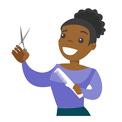 Image showing Hairdresser holding comb and scissors in hands.