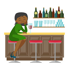 Image showing Sad african-american woman drinking wine in a bar.