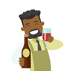 Image showing African waiter holding glass and bottle of wine.