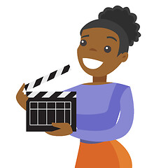 Image showing Young african woman holding a movie clapper board.