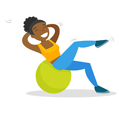 Image showing African-american woman exercising with fitball.