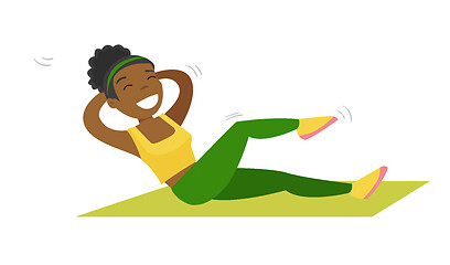 Image showing Young african-american woman doing crunches.