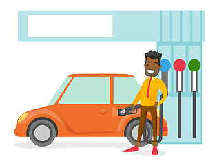 Image showing Man filling up fuel into the car at a gas station.