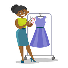 Image showing African woman cutting price tag off new dress.