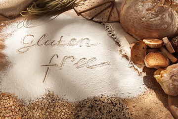 Image showing Gluten free food. Various pasta, bread and snacks on wooden background from top view