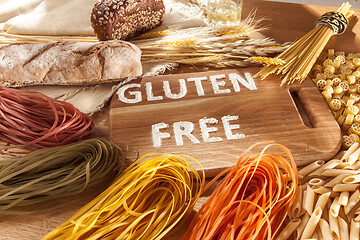 Image showing Gluten free food. Various pasta, bread and snacks on wooden background from top view