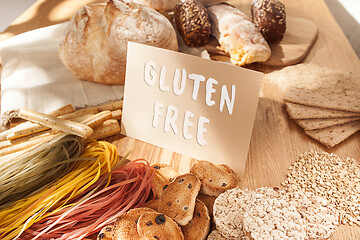 Image showing Gluten free food. Various pasta, bread and snacks on wooden background from top view