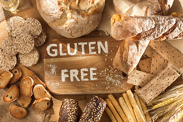 Image showing Gluten free food. Various pasta, bread and snacks on wooden background from top view