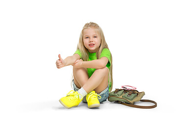 Image showing Full length portrait of cute little kid in stylish jeans clothes looking at camera and smiling