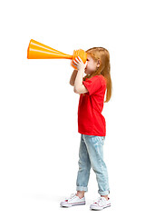 Image showing Full length portrait of cute little kid in stylish jeans clothes looking at toy binoculars