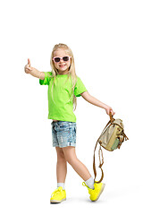 Image showing Full length portrait of cute little kid in stylish jeans clothes looking at camera and smiling