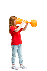 Image showing Full length portrait of cute little kid in stylish jeans clothes looking at toy binoculars