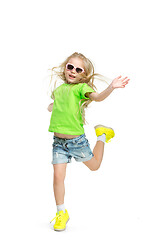 Image showing Full length portrait of cute little kid in stylish jeans clothes looking at camera and smiling