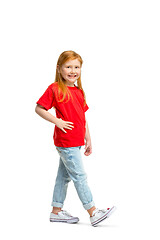 Image showing Full length portrait of cute little kid in stylish jeans clothes looking at camera and smiling