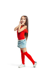 Image showing Full length portrait of cute little kid in stylish jeans clothes looking at camera and smiling