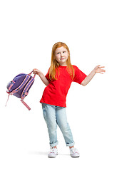 Image showing Full length portrait of cute little kid in stylish jeans clothes looking at camera and smiling