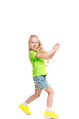 Image showing Full length portrait of cute little kid in stylish jeans clothes looking at camera and smiling