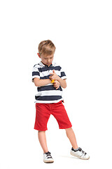 Image showing Full length portrait of cute little kid in stylish clothes looking at camera and smiling