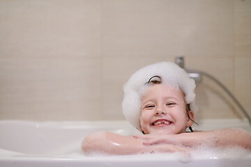 Image showing little girl in bath playing with soap foam