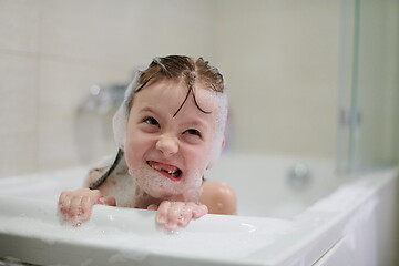 Image showing little girl in bath playing with soap foam