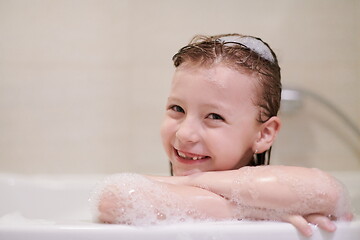 Image showing little girl in bath playing with soap foam