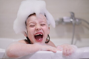 Image showing little girl in bath playing with soap foam