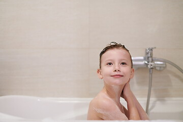 Image showing little girl in bath playing with soap foam