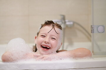 Image showing little girl in bath playing with soap foam