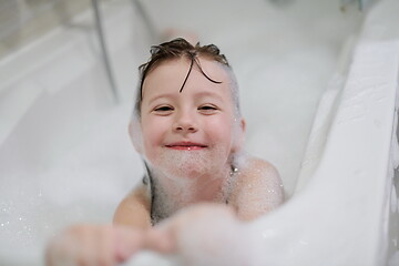 Image showing little girl in bath playing with soap foam