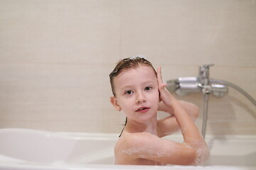 Image showing little girl in bath playing with soap foam