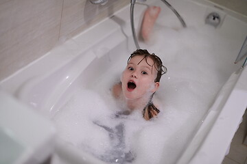 Image showing little girl in bath playing with soap foam