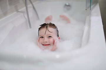 Image showing little girl in bath playing with soap foam