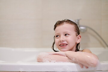 Image showing little girl in bath playing with soap foam