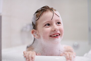 Image showing little girl in bath playing with soap foam