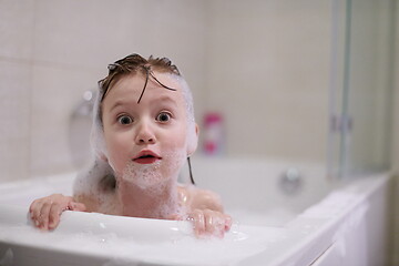 Image showing little girl in bath playing with soap foam