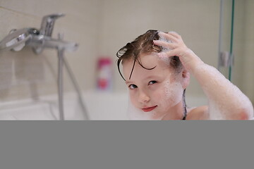 Image showing little girl in bath playing with soap foam