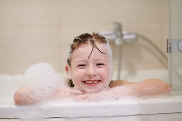 Image showing little girl in bath playing with soap foam