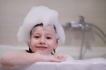 Image showing little girl in bath playing with soap foam