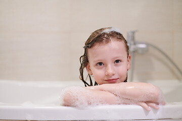 Image showing little girl in bath playing with soap foam