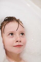 Image showing little girl in bath playing with soap foam