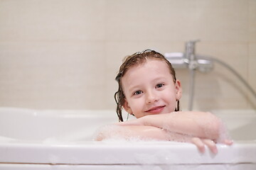 Image showing little girl in bath playing with soap foam