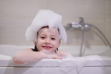 Image showing little girl in bath playing with soap foam