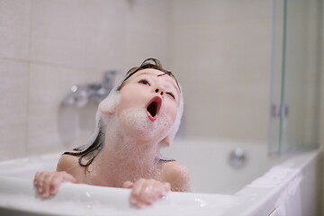 Image showing little girl in bath playing with soap foam