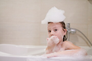 Image showing little girl in bath playing with soap foam