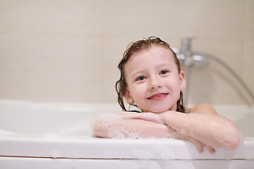 Image showing little girl in bath playing with soap foam