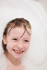 Image showing little girl in bath playing with soap foam