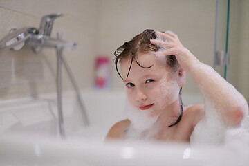 Image showing little girl in bath playing with soap foam