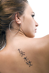 Image showing Tattoo on a back of the young woman. Isolated 3